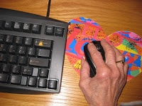 sex after 50 - older hand using mouse on heart shaped mouse pad