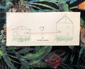 drawing of 2 houses joined by love