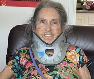 Joan Price wearing neck brace after accident