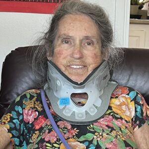 Joan Price wearing neck brace after accident